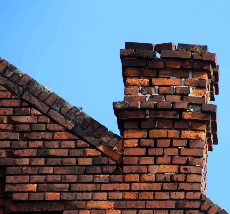 Signs Your Roselle Home Needs a Chimney Inspection Damaged chimney on an Roselle home showing cracks and missing mortar